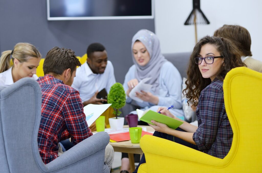 co-workers sitting at the office discussing work-related topics